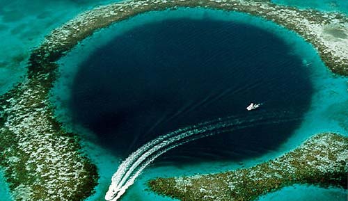 A boat is traveling through a blue hole in the ocean, offering freight services to the Bahamas and Exuma.