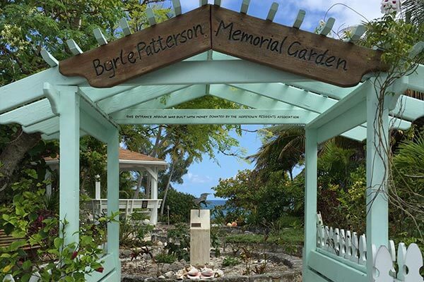 A gazebo with a sign that says byron edwards memorial garden offering daily freight services to the Bahamas and air freight to Exuma.
