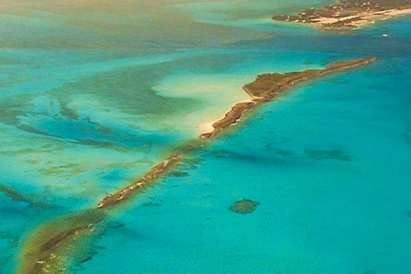 An aerial view of an island in the ocean with daily freight services to the Bahamas.