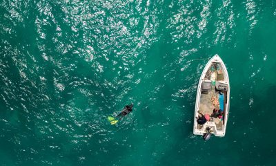 Aerial view of a small boat in the ocean during a charter flight to the Bahamas. Governor's Harbour